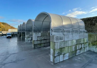 Modular TUFFShel Lite bays installed on concrete block walls, creating flexible, weather-protected storage for aggregates and materials.