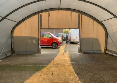 Internal view of a TUFFShel Lite used as a vehicle maintenance bay, offering a bright, sheltered workspace with easy access.