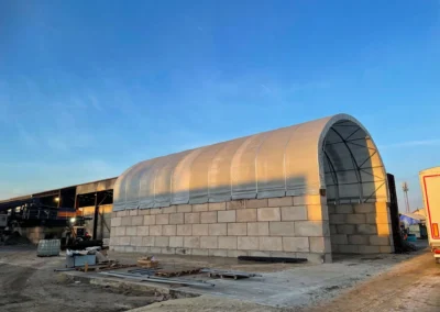 TUFFShel Max installed on Lego block walls, creating a high-capacity covered storage bay with easy access.