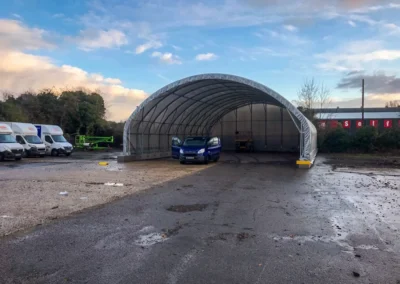 14m wide TUFFShel Max large span shelter providing open, accessible covered space for vehicles and site operations.