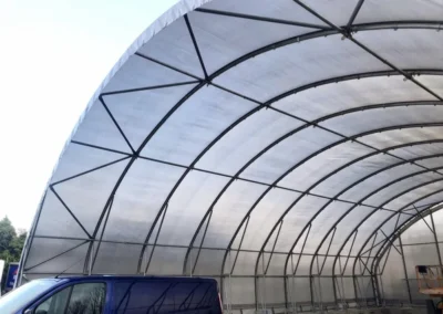14m wide large span industrial shelter showing clear span steel frame and high internal working space.