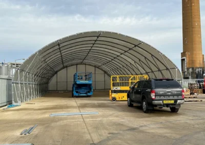 A TUFFShel Max 14m wide, 32m long large span shelter providing extensive covered space for vehicles, equipment, and operations.